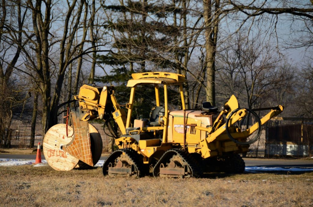 a yellow bulldozer is parked in a field